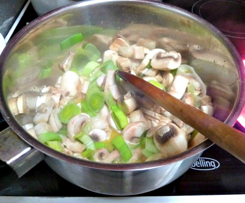 chopped leeks and mushrooms in a pan to make chicken pie with