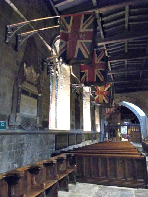 Regimental flags hanging from the wall of Newcastle cathedral