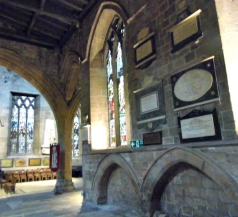 Inside St Nicholas cathedral showing stonework and stained glass windows in the background