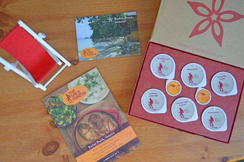 The contents of the spice pioneer spice subscription box shown on a wooden background.
