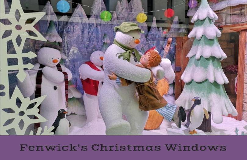The snowman dancing with boy in christmas window display