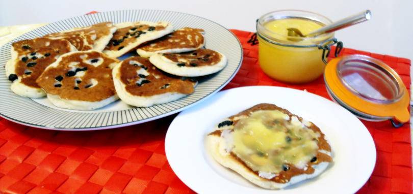 Scotch pancakes on a plate with lemon curd
