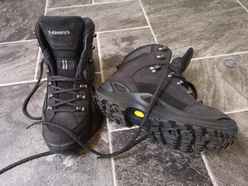 Lowa renegade walking boots on tiles with one tipped so you can see the sole