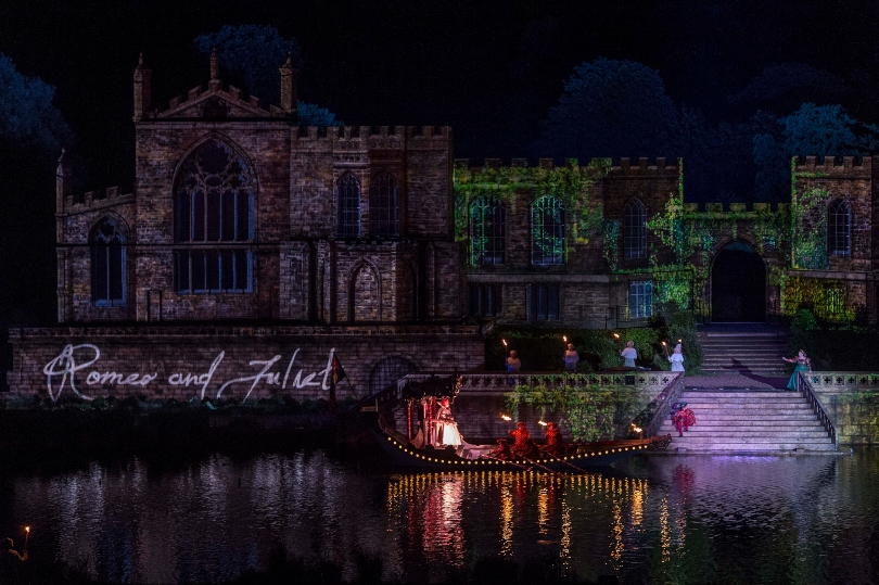Shakespeares barge at Kynren on the river passing in front of the castle