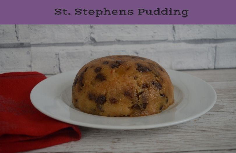 St Stephen's Pudding on a plate with a red napkin beside it. This is a steamed apple pudding
