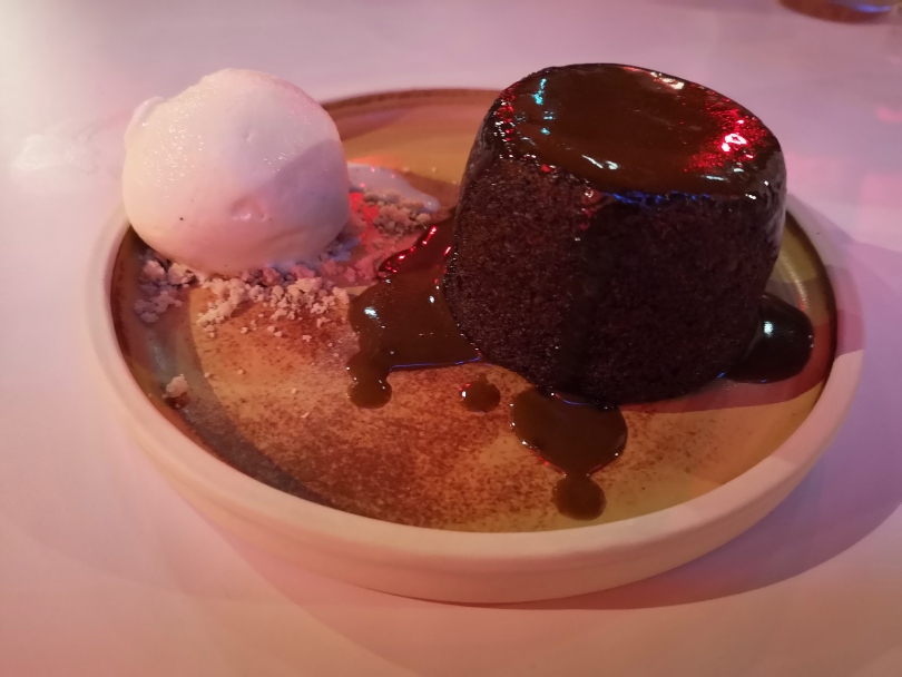 sticky toffee pudding on a plate with ice cream