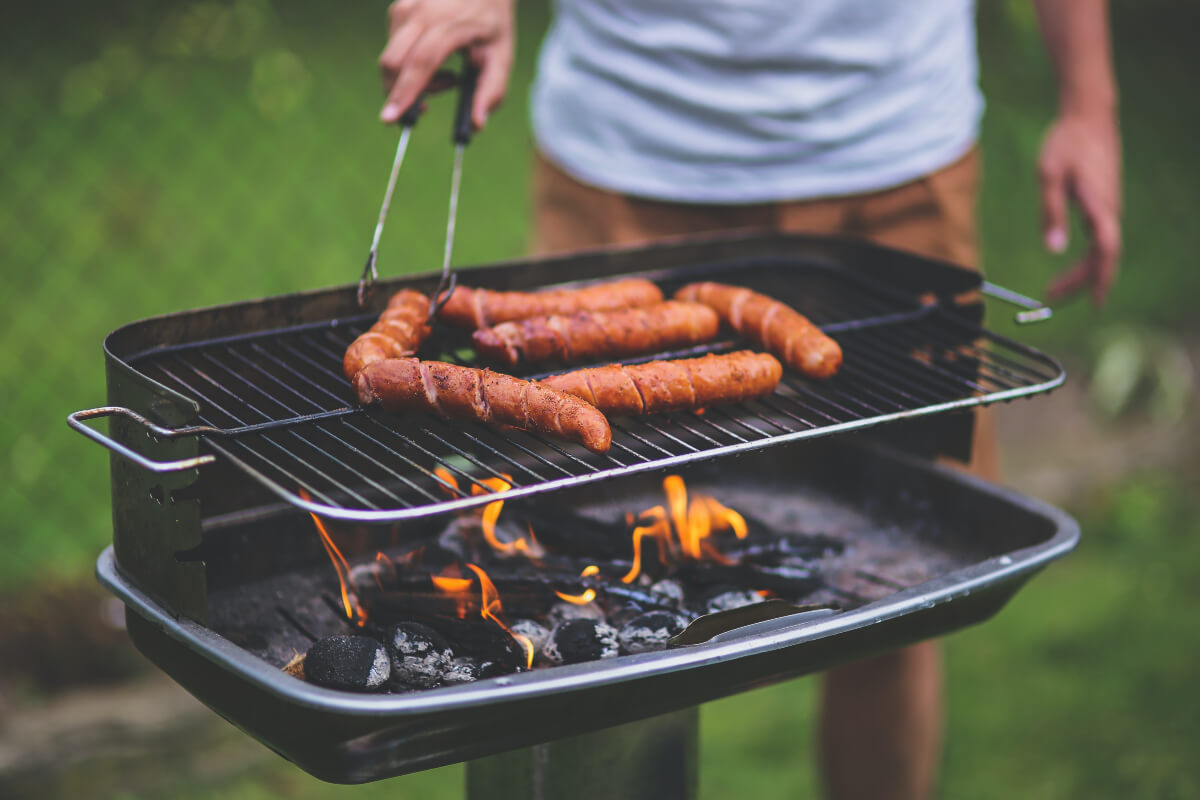 Man grilling sausages on a barbecue