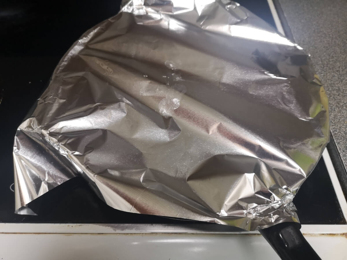 Pan Haggerty cooking gently in covered frying pan