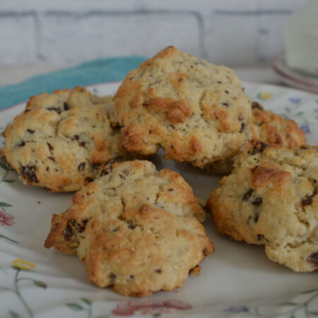 A flowery plate with five rock cakes on it