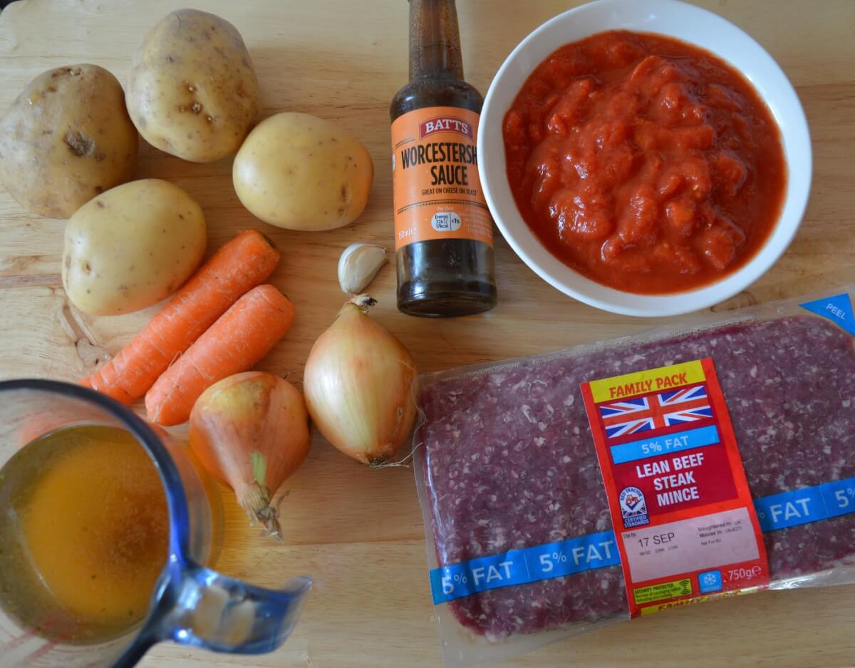 Ingredients for homemade cottage pie with minced beef, potatoes, carrots and tomatoes