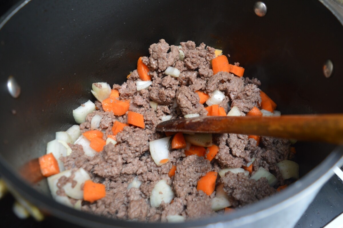 Minced beef cooking with onion and carrots.