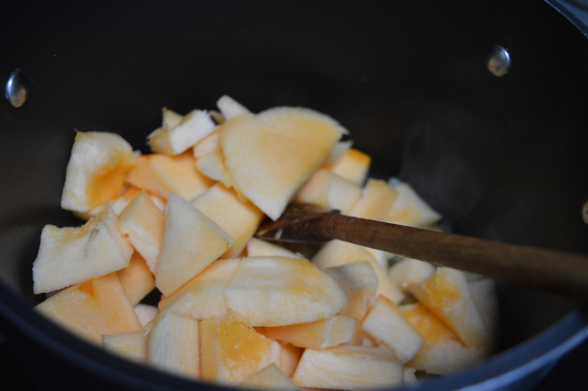 Chunks of freshly chopped pumpkin in a large saucepan, ready to be cooked into pumpkin soup.