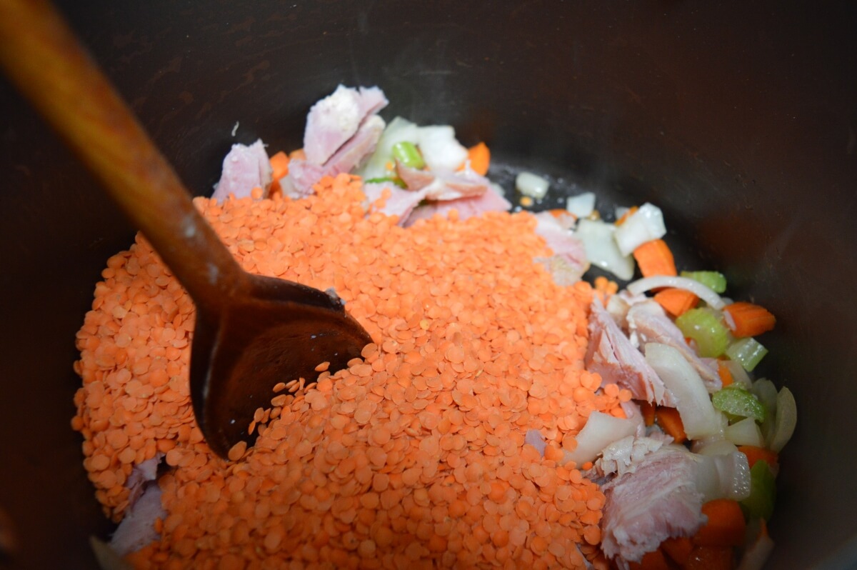 Red lentils added to the saucepan