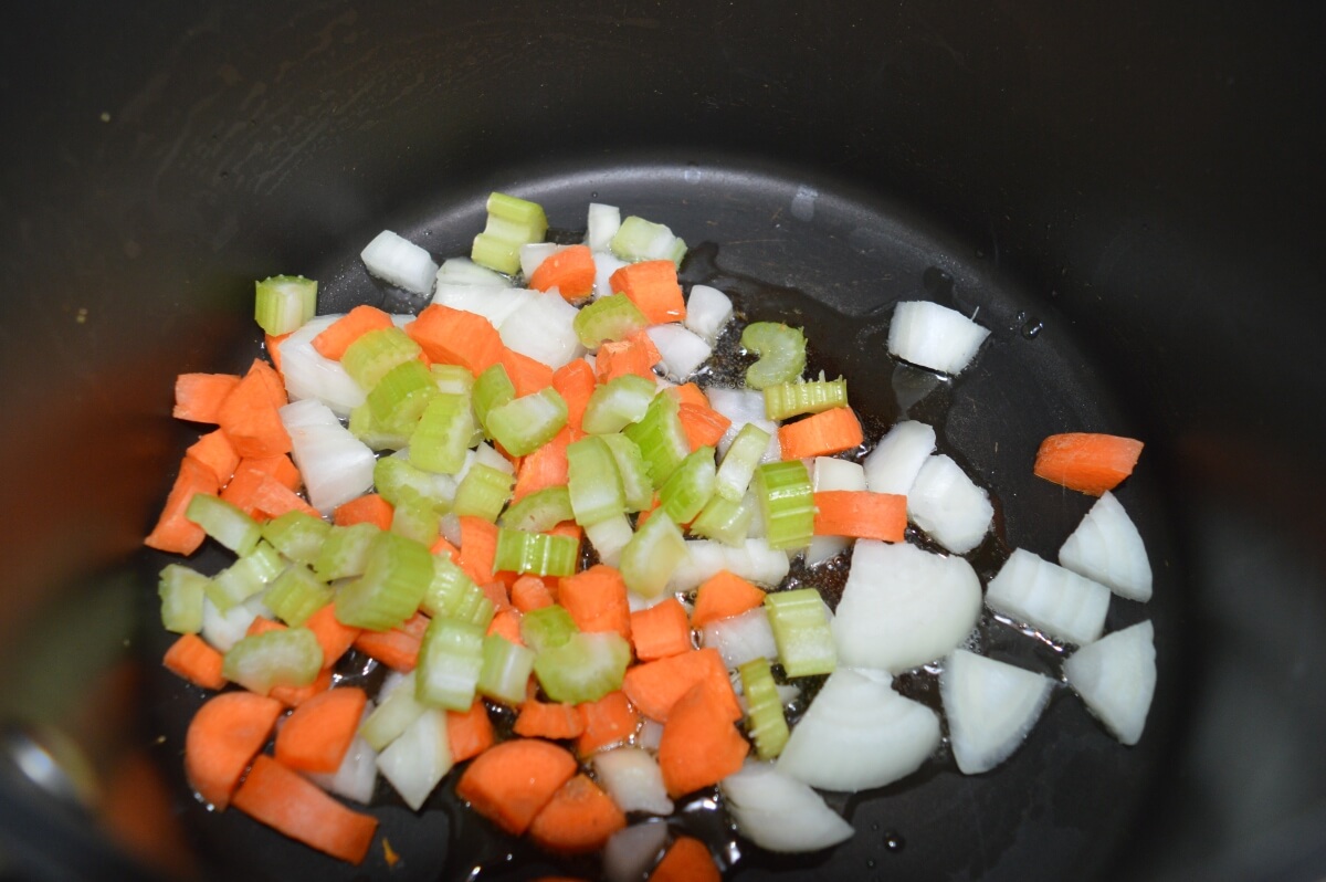 Onion, carrot and celery softening in a saucepan