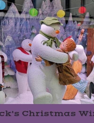 The snowman dancing with boy in christmas window display