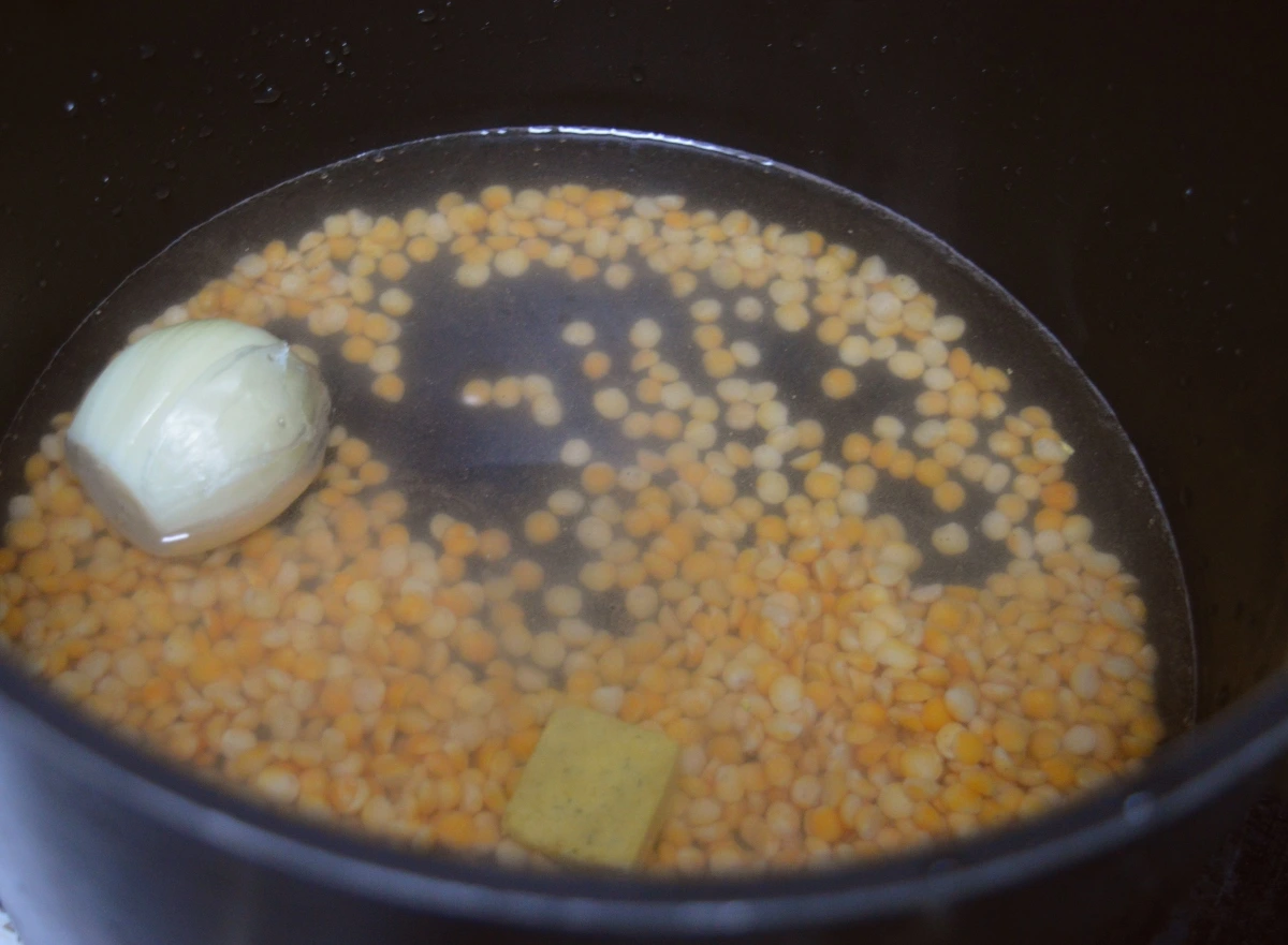 Yellow split peas, onion, stock cube and water in pan