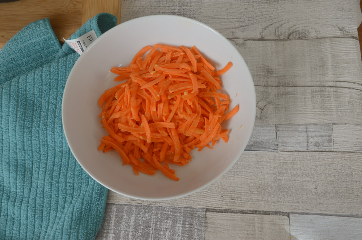 Grated carrot in a bowl on a table