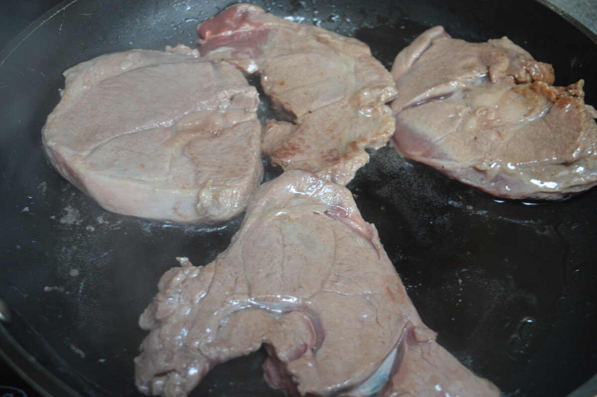 Lamb chops browning in a pan