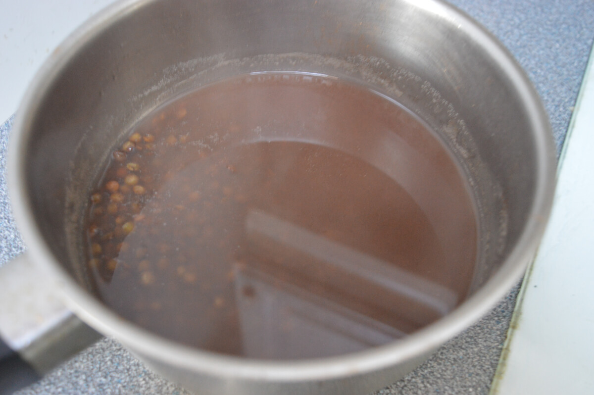 brown lentils soaking in a pan