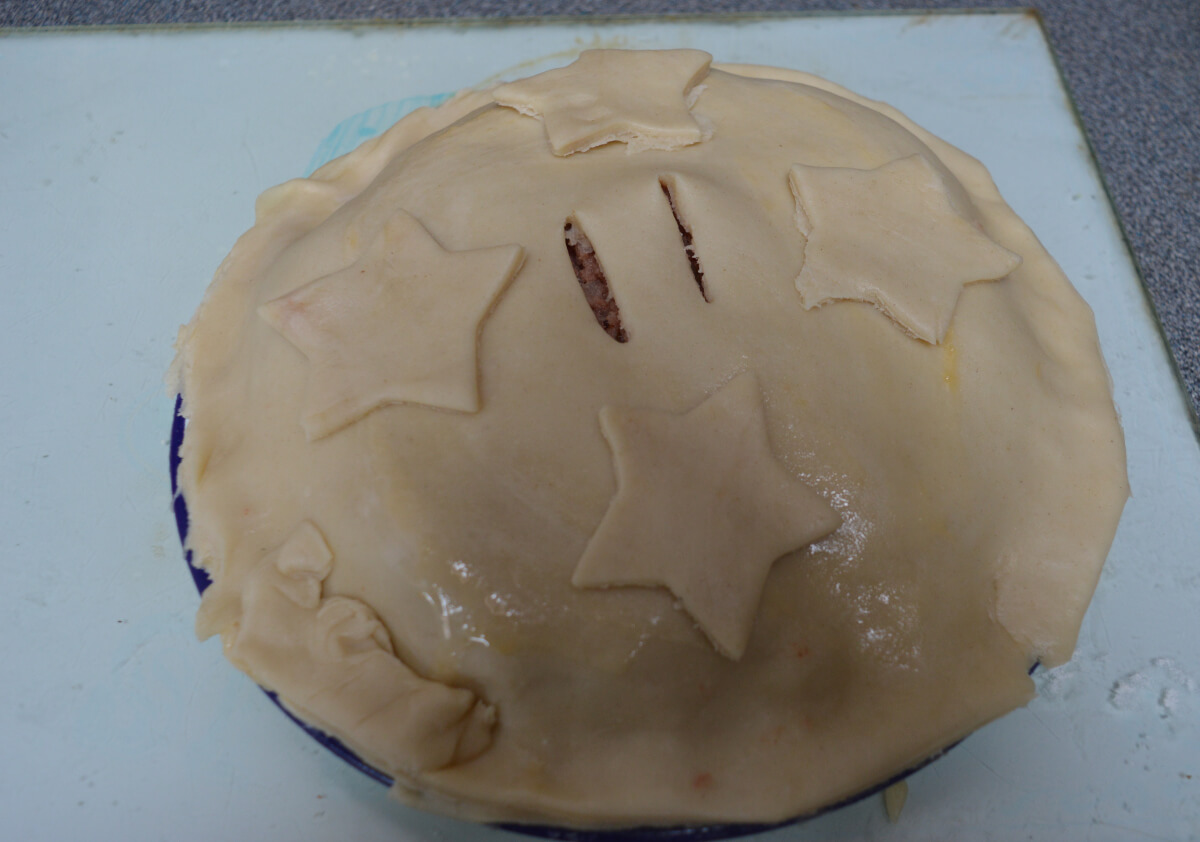 Corned beef pie on plate ready to be cooked