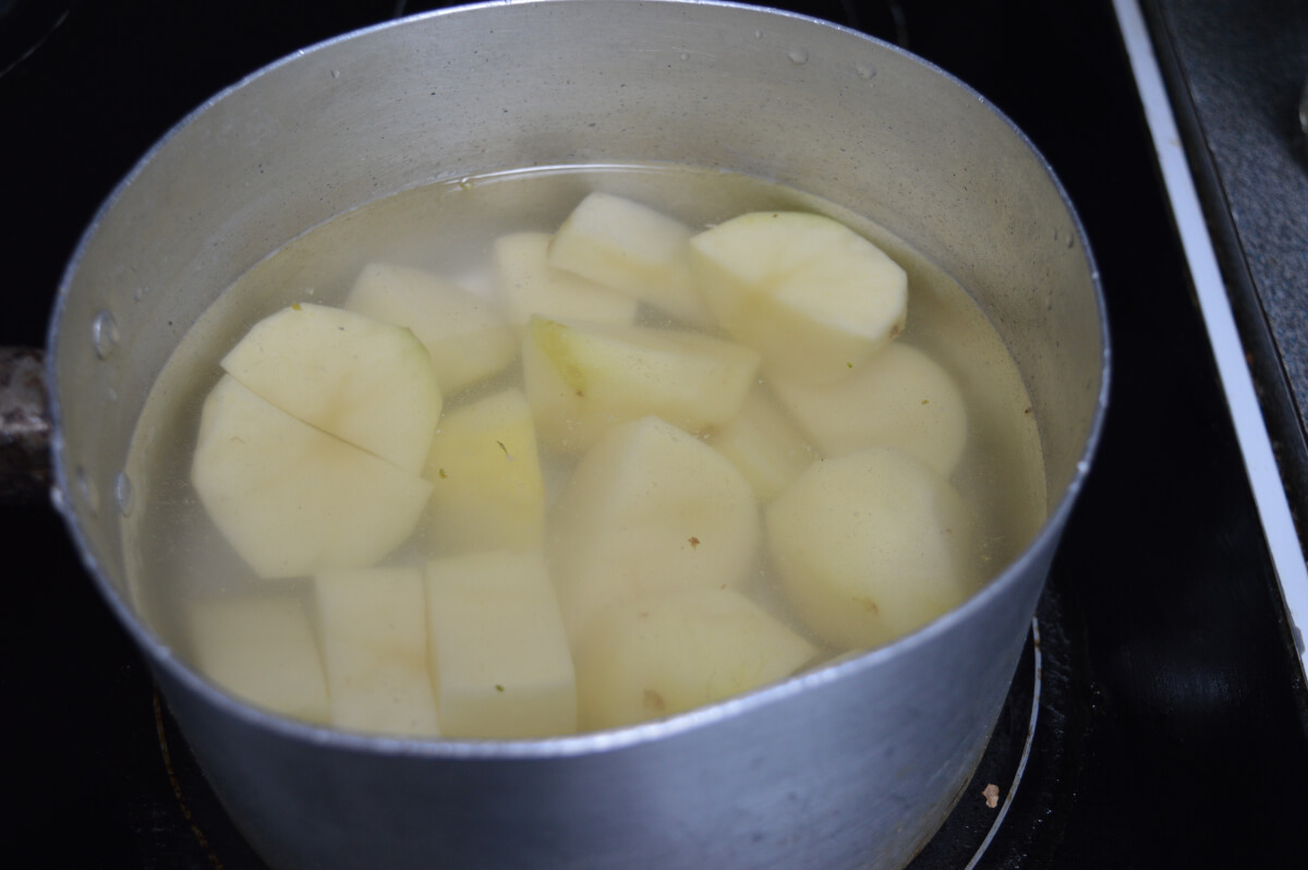 Peeled and chopped potatoes in a pan of water