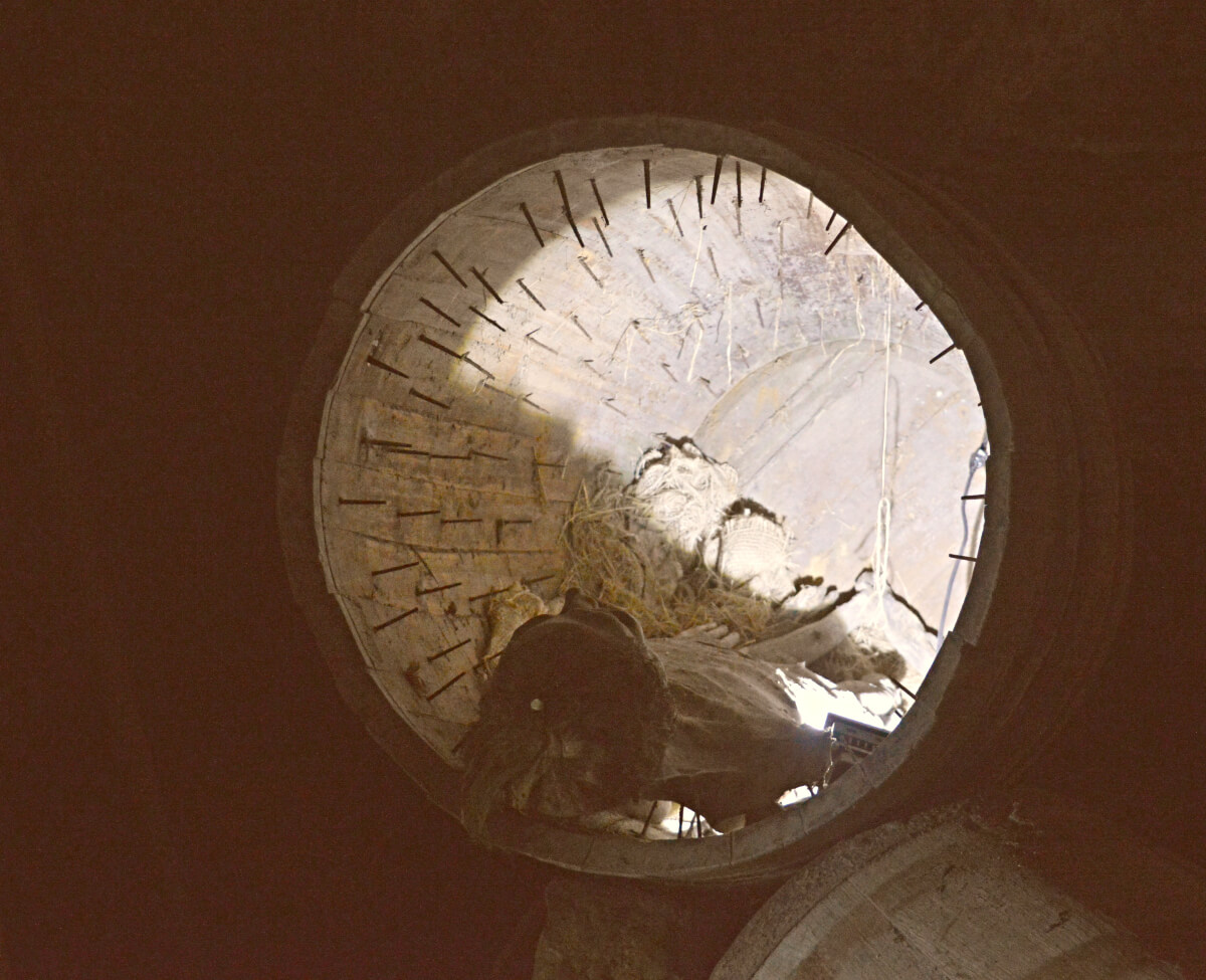A barrel full of nails with a persons skeleton inside