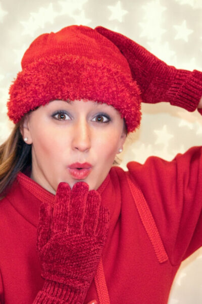 Woman in red blowing a kiss