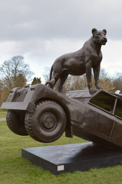 A statue of Elsa the lion on a landrover
