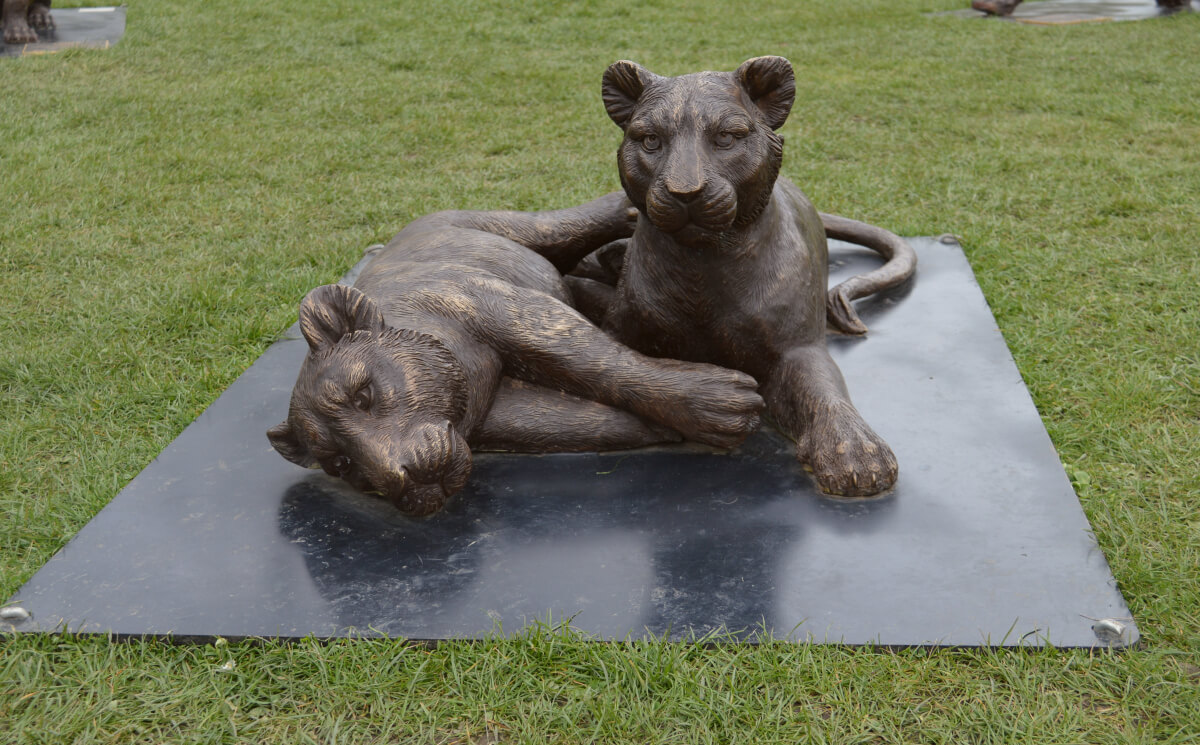 Statue of two lion cubs playing
