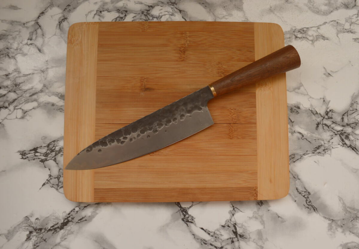 Katto chef's knife on wooden chopping board