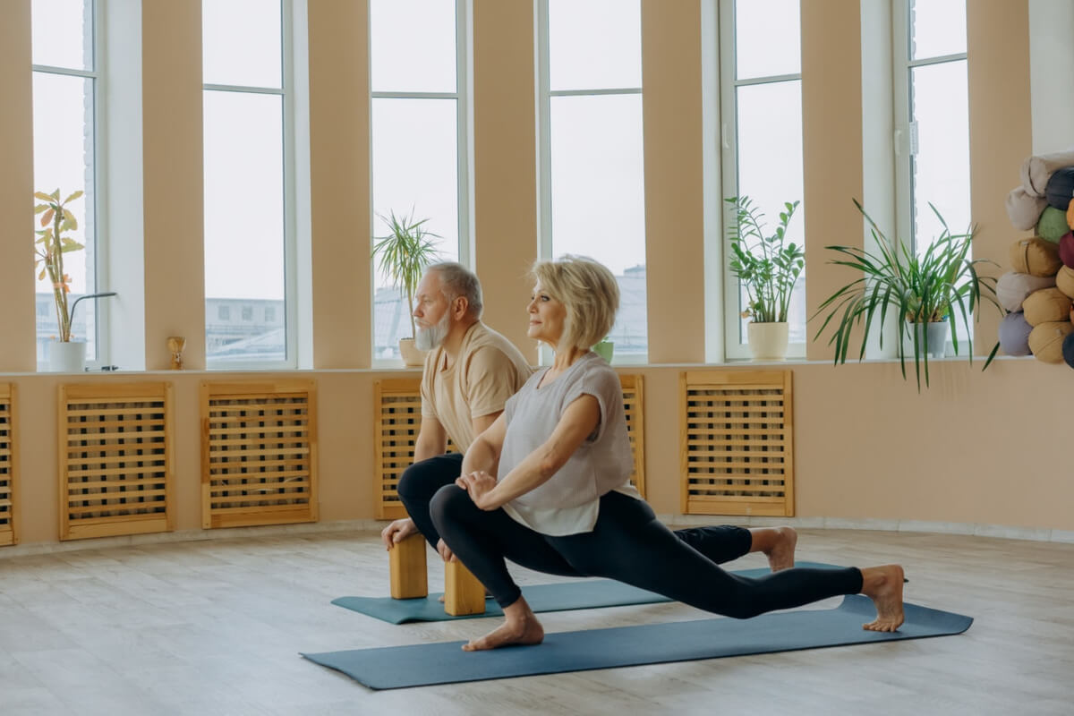 Elderly man and woman doing stretches