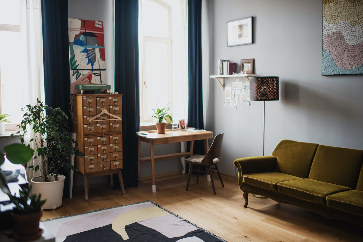Modern interior style with cosy sofa and wooden drawers