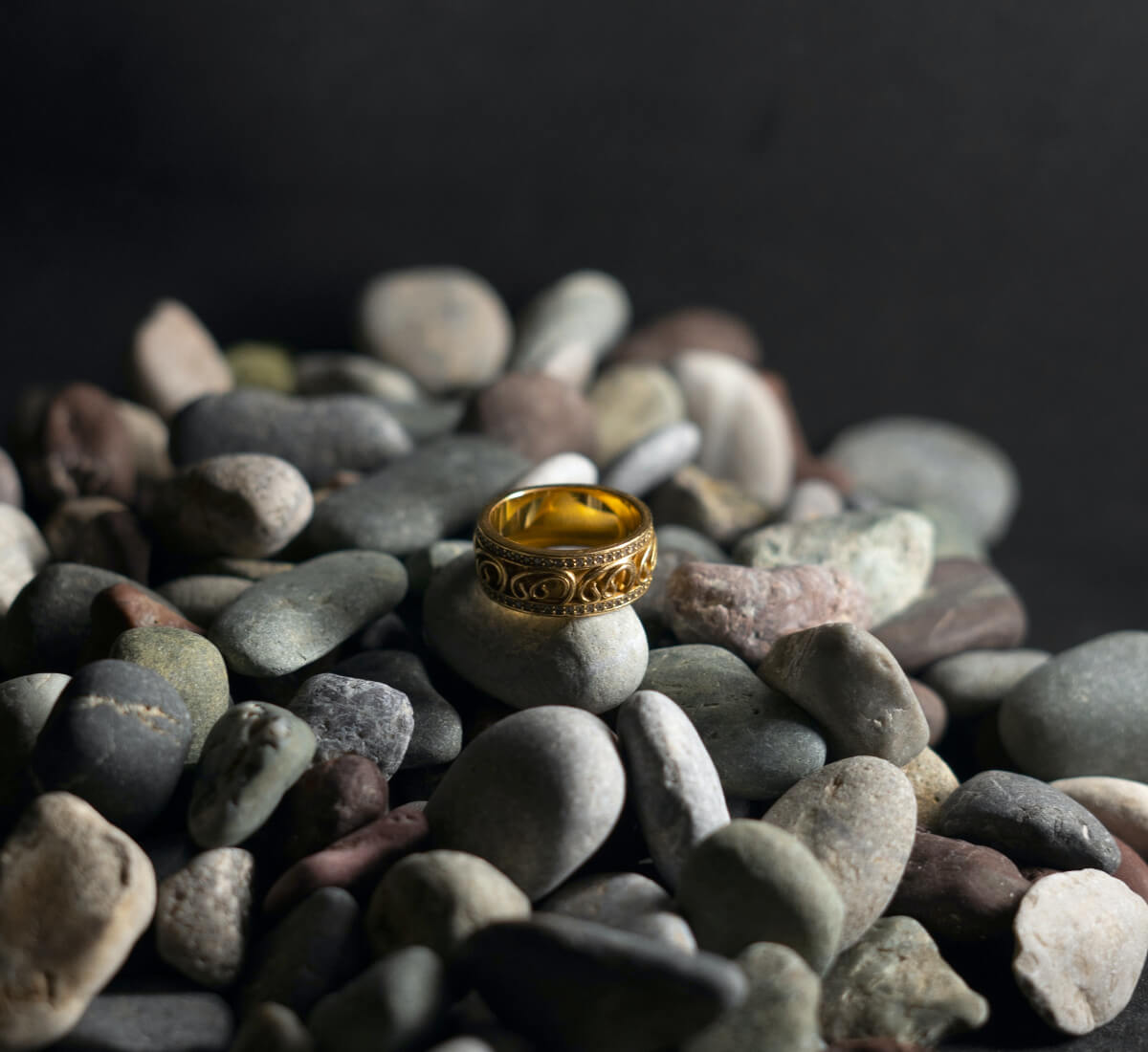 Gold ring displayed on stones