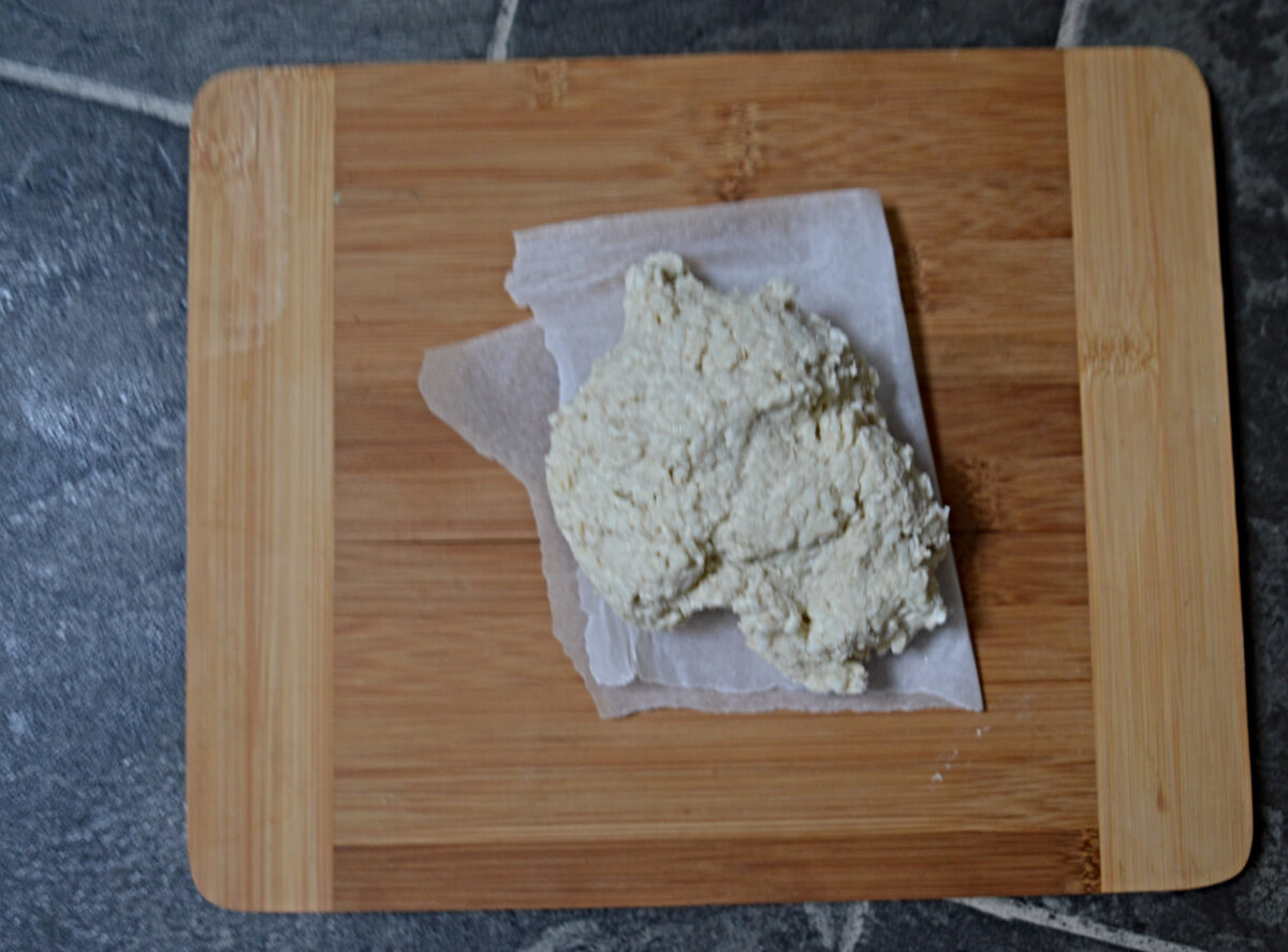 Dough rolled into a ball on a chopping board