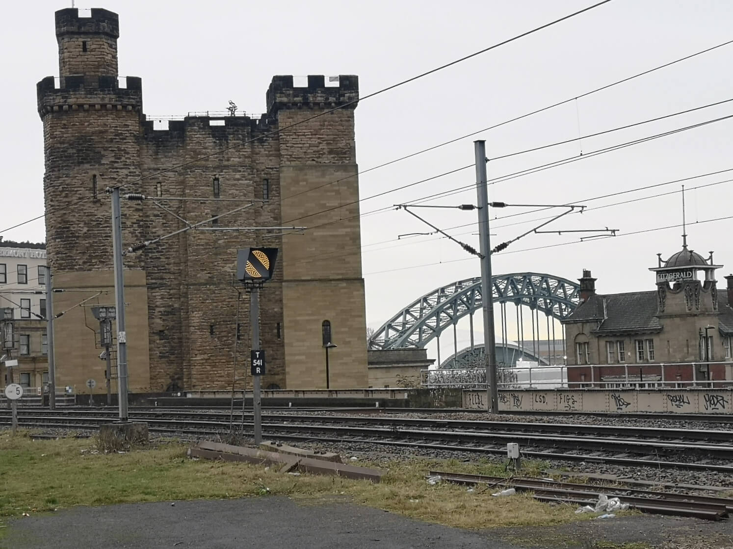 Newcastle Castle Keep seen across the railway with the Tyne Bridge behind