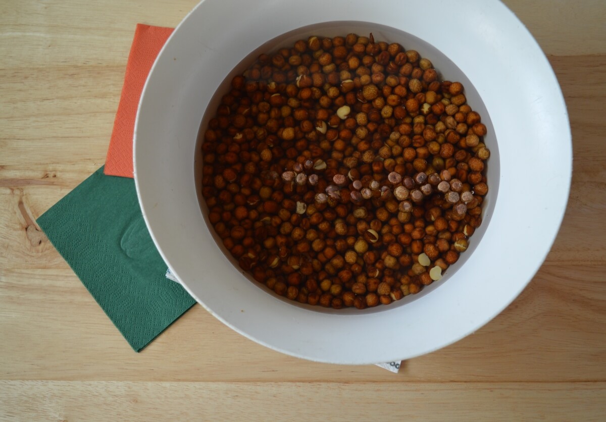 Dried carlin peas soaking overnight in a bowl of water.