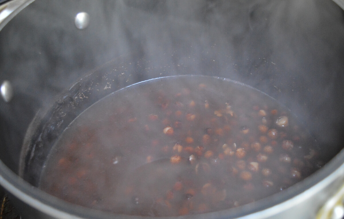Carlin peas simmering in a saucepan until tender.