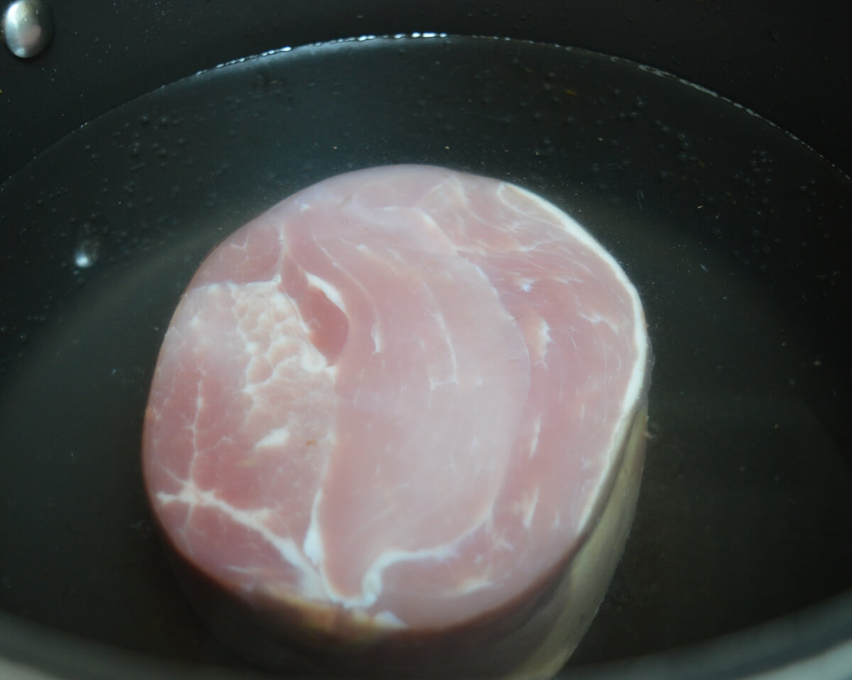 A gammon joint in a large pan ready to make homemade stock.