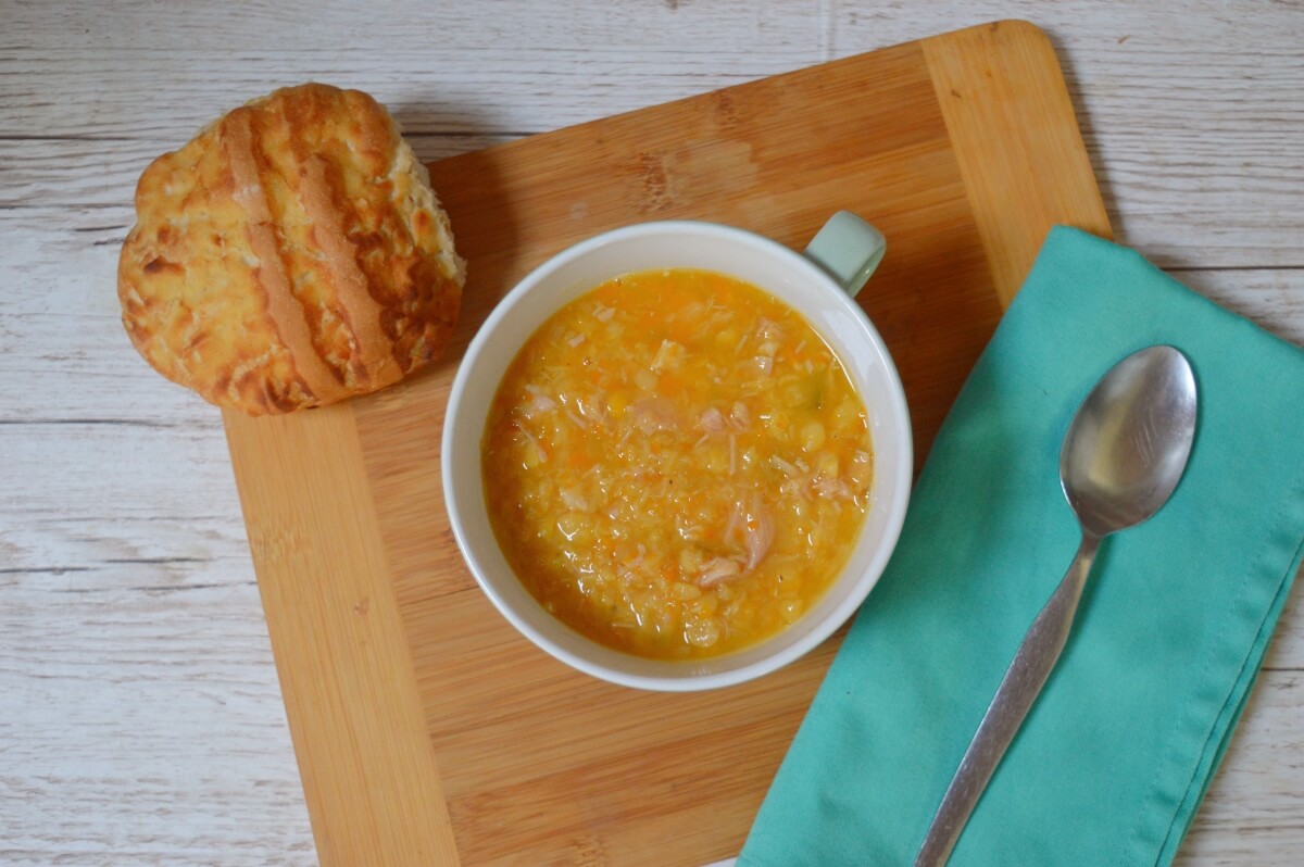 Northumberland Ham Broth in a bowl with a crusty bread roll