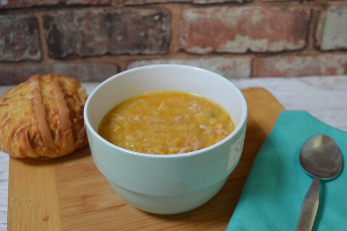Traditional Northumberland ham broth served in a bowl with a fresh bread roll.