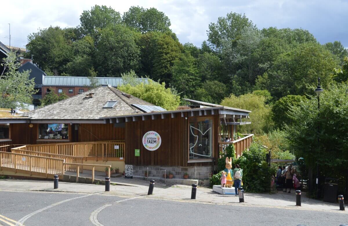 Ouseburn Farm in Newcastle with raised beds and the farm buildings behind