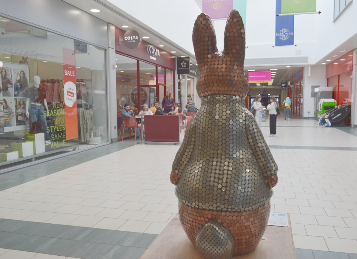 Back of Bunny Bank Peter Rabbit showing the coin-covered jacket and tail
