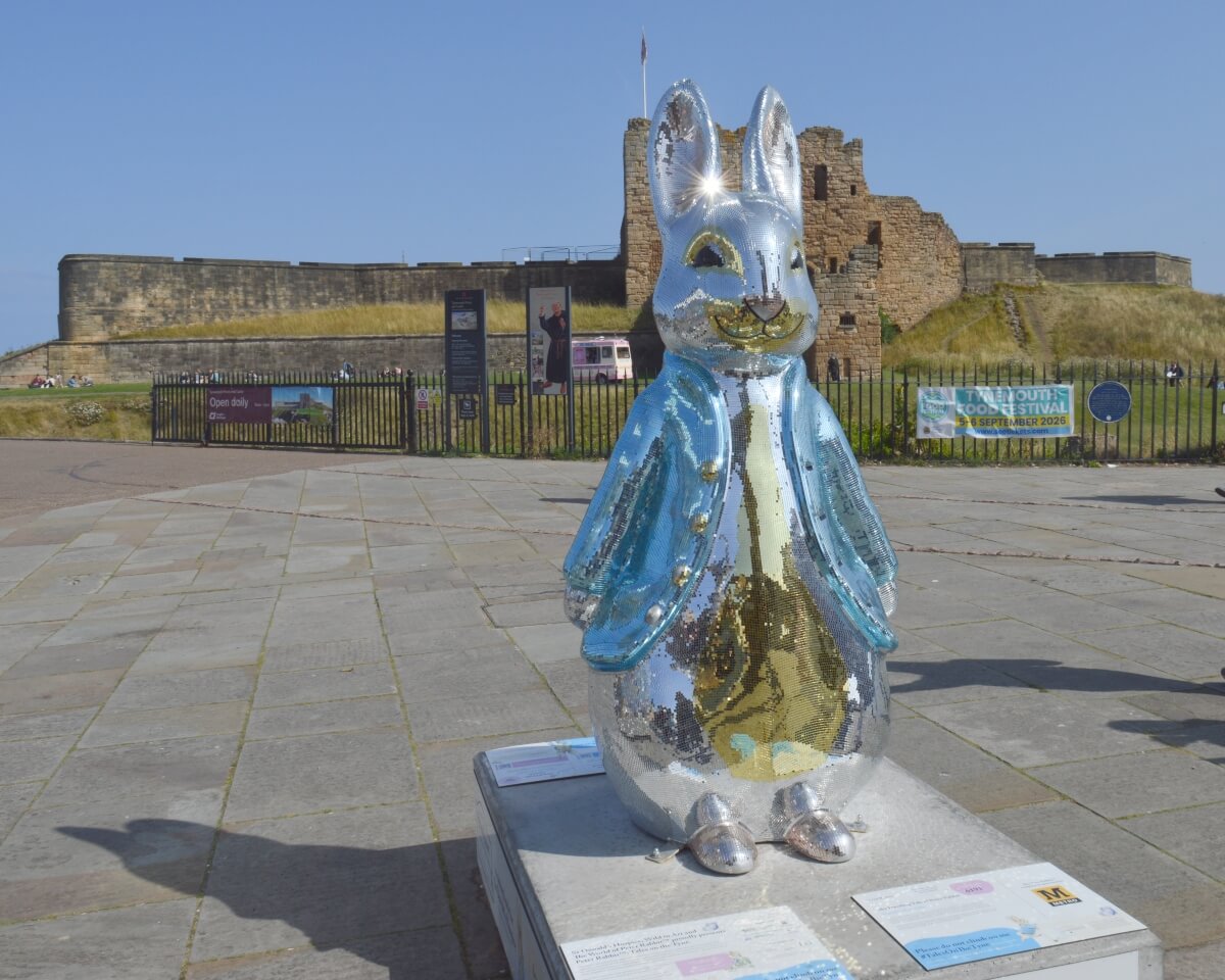 The Dazzling Tale of Peter Rabbit mirrored sculpture in front of Tynemouth Priory and Castle