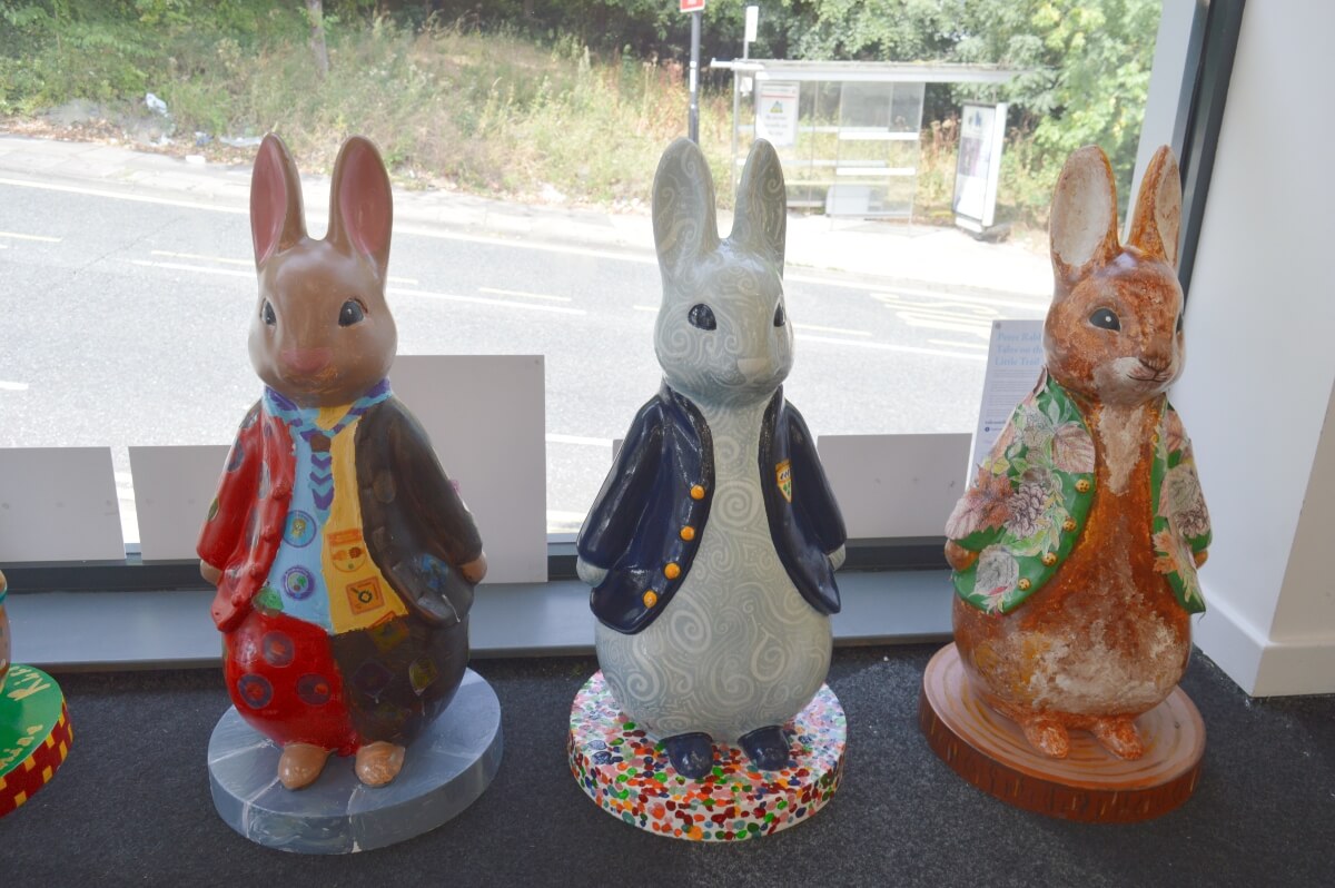 Three Peter Rabbit fluffles displayed by the window at Peter Rabbit Trail HQ in Ouseburn