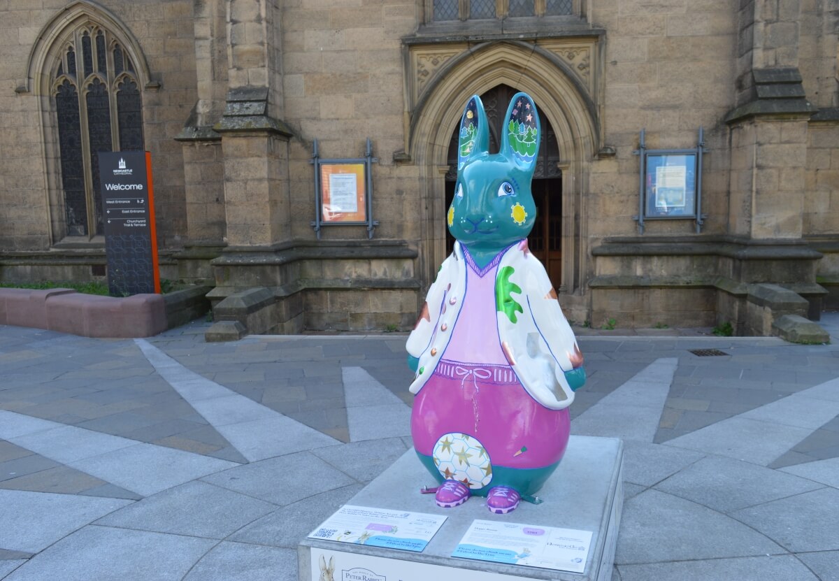 Happy Bunny Peter Rabbit sculpture with a football outside Newcastle Cathedral