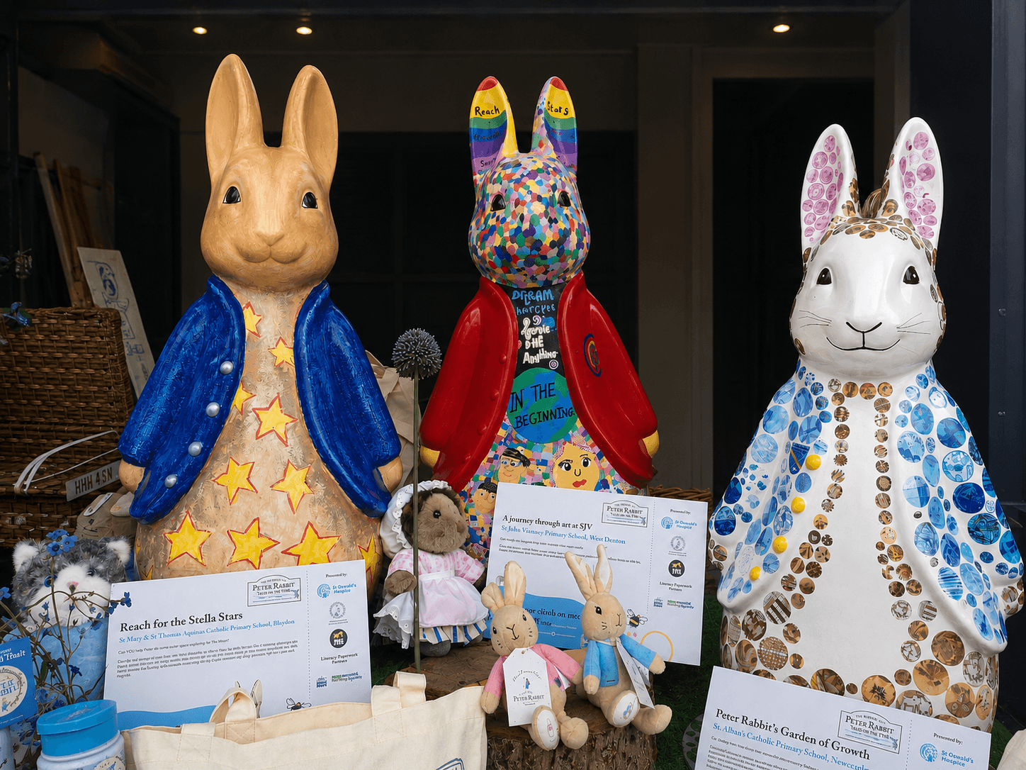 Three Peter Rabbit Fluffles created by local schools in the St Oswald's Hospice shop window in Jesmond