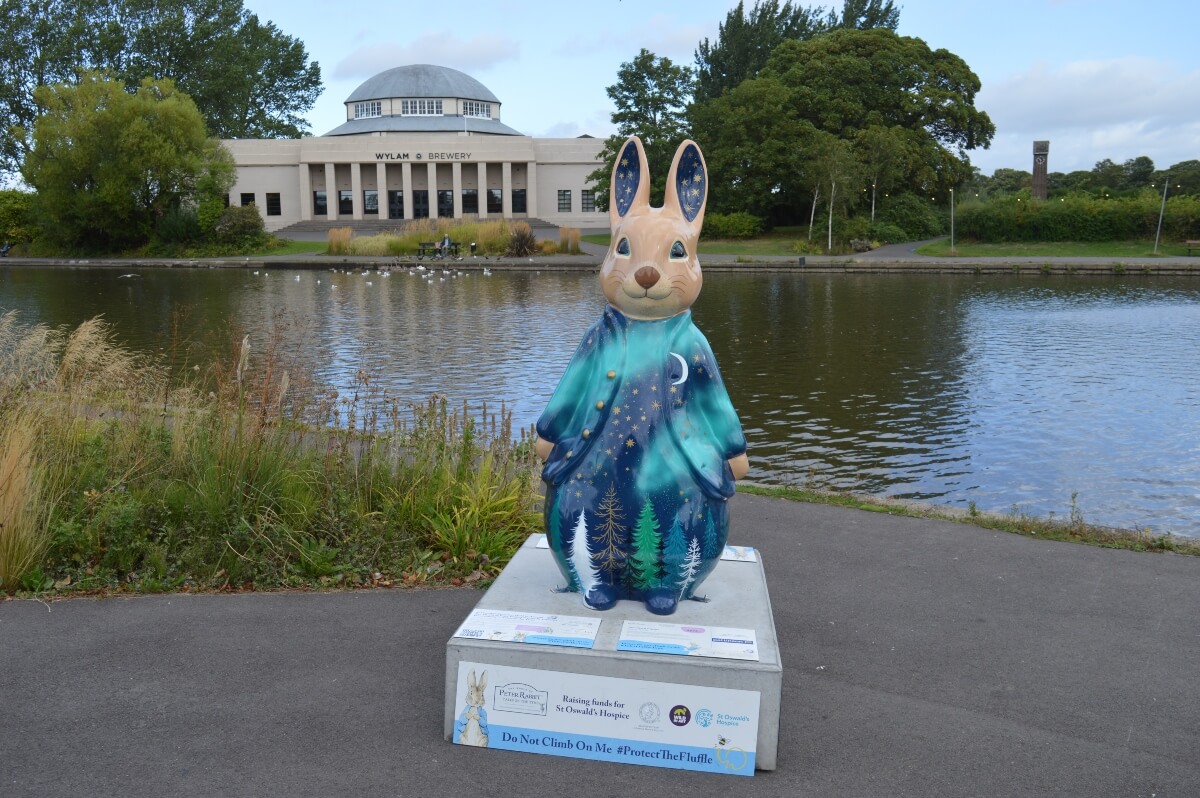 Northern Lights Peter Rabbit sculpture by Kirsty Reilly beside the lake in Exhibition Park Newcastle