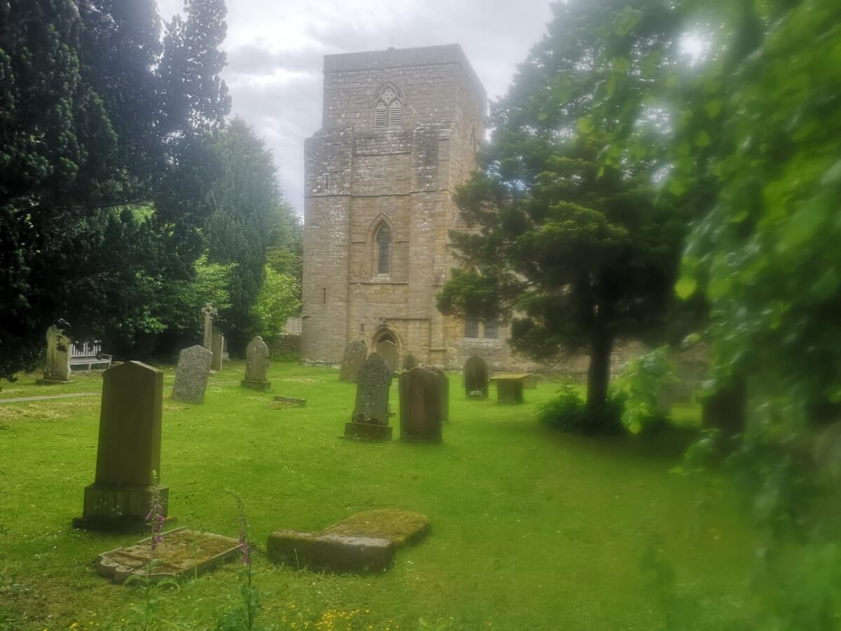 St Mary’s Church tower and graveyard in Blanchland, Northumberland