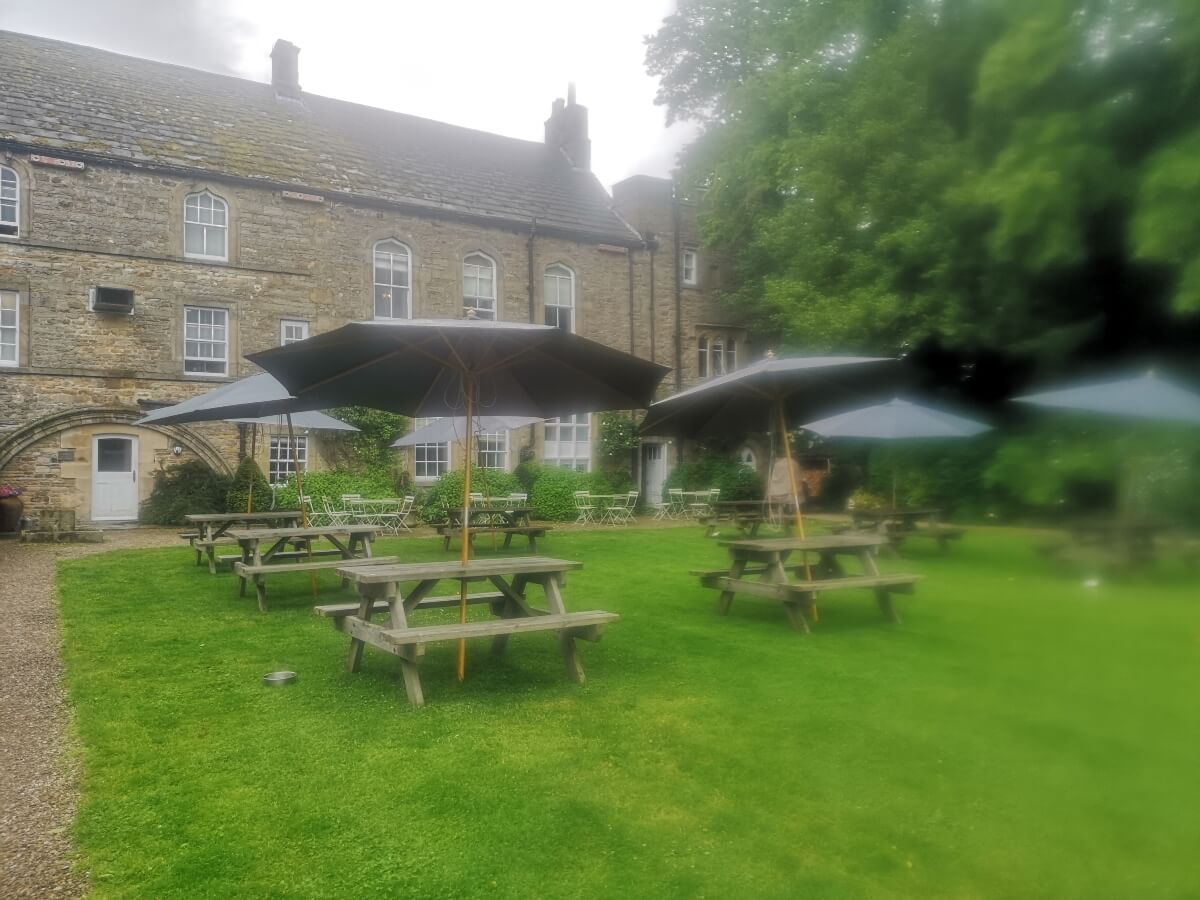 Stone arch beside the former abbey cloister at the Lord Crewe Arms